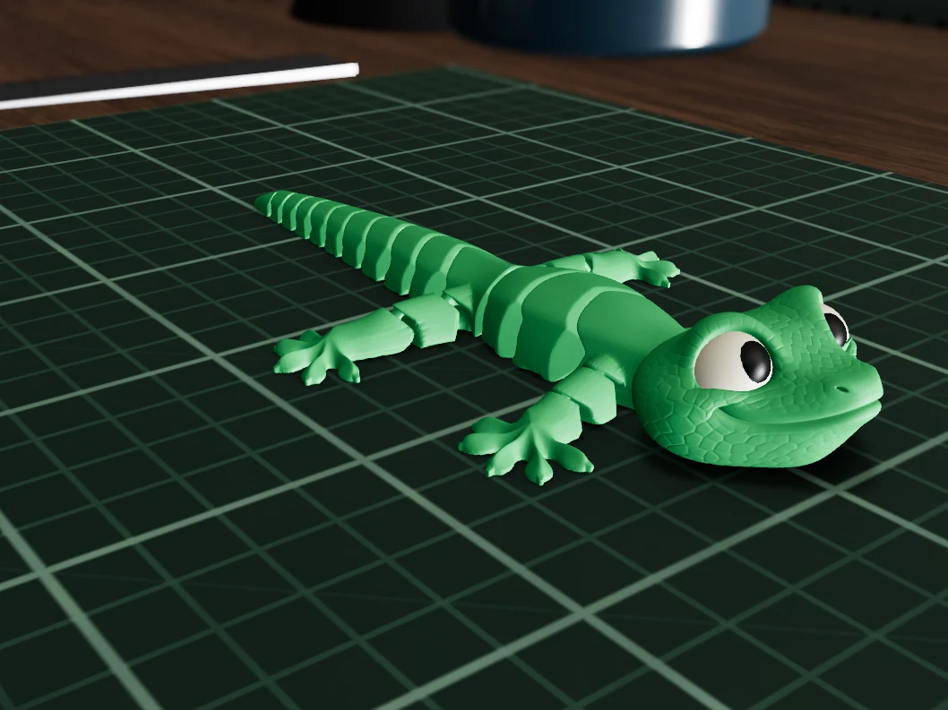 Flexy Gecko in Fern PLA on a maker's workbench